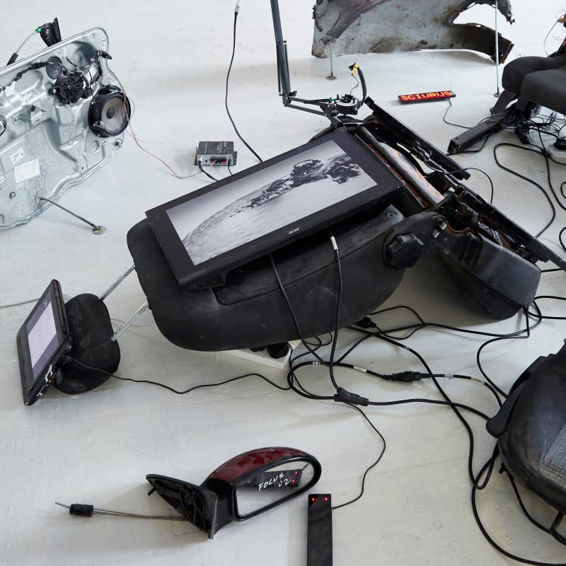 Installation by Livia Harper featuring broken car parts and digital screens - BA Fine Art at Chelsea College of Arts.