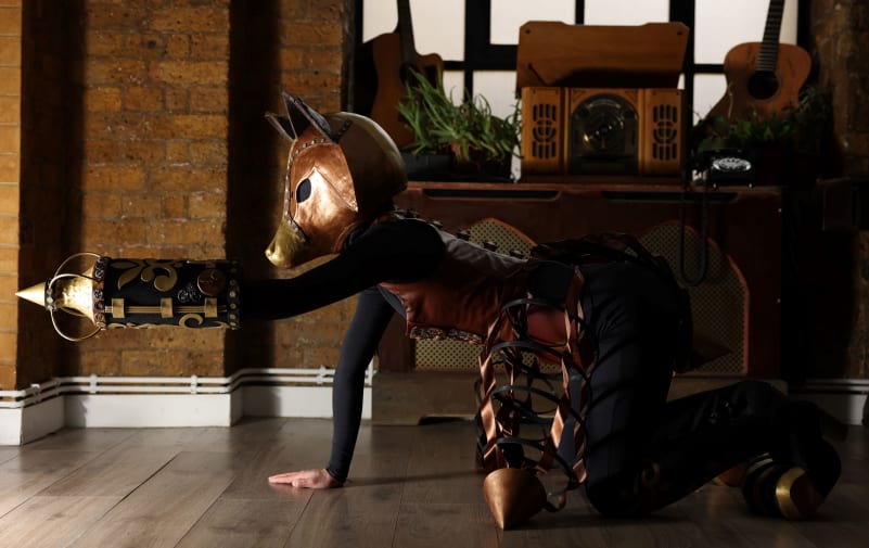Model in animal mask on all fours.