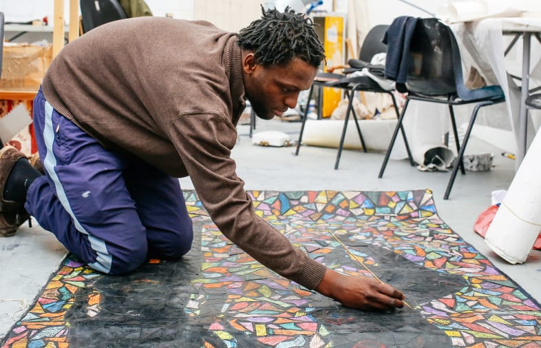 Fungai Benhura painting in the Studio