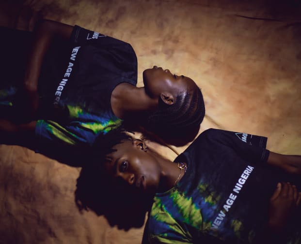 Two Black people lying head to head on the floor. By Safeen James  from their collection Animus