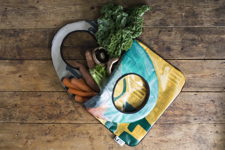 Colourful vinyl bag with healthy vegetables spilling picturesquely out 