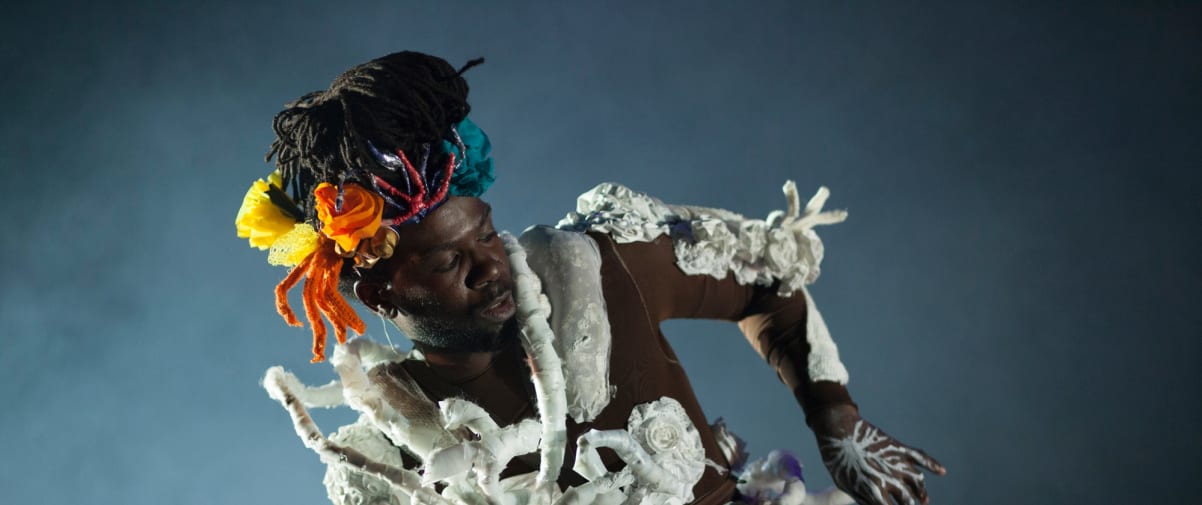 Performer wearing a a costume made of coral.