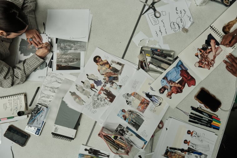 student working on collage of images