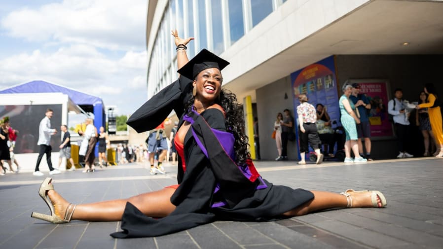 LCFalum doing the splits outside the graduation ceremony in London