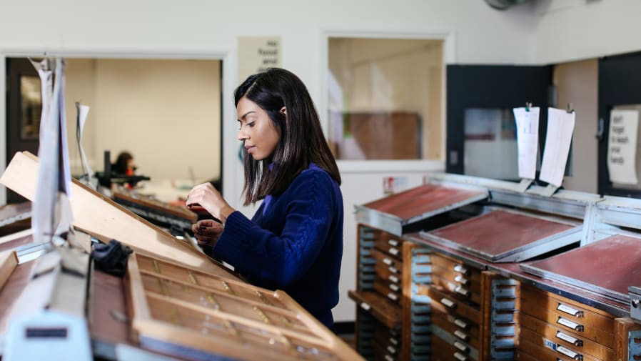 Student making work in the Letterpress studio