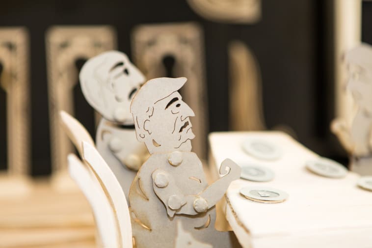 Cardboard characters at a dinner table - part of BA Live Events and Television course project