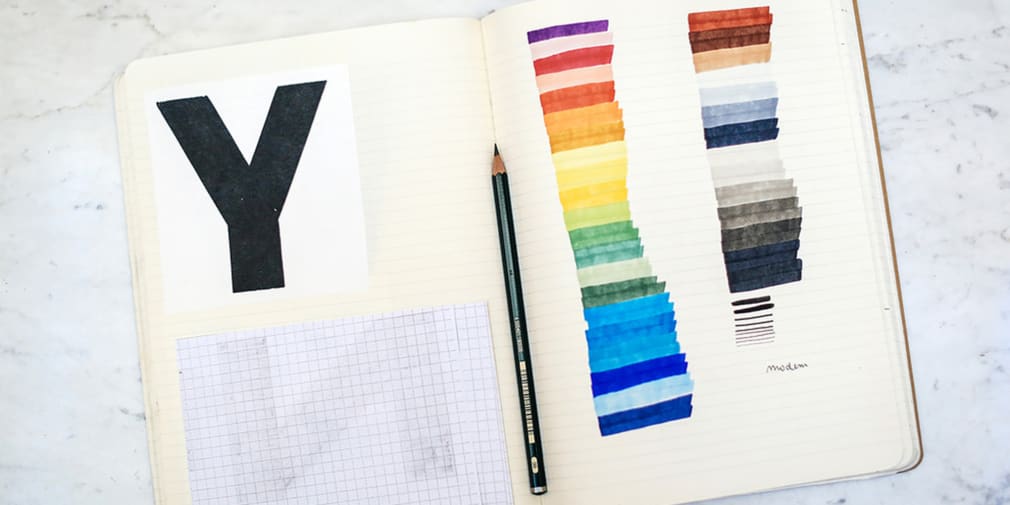 Sketchbook with rainbow coloured lines.