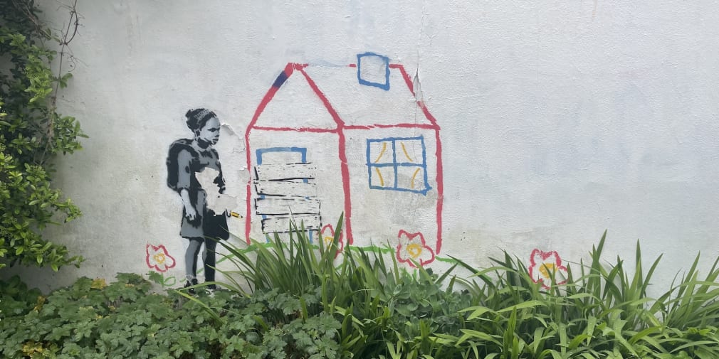 A photograph of a possible graffiti on the wall by Banksy
