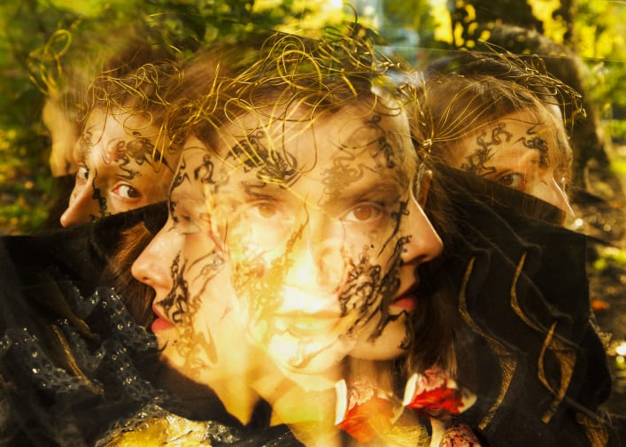 Mirroring portraits of a woman overlapping one other through overexposure.
