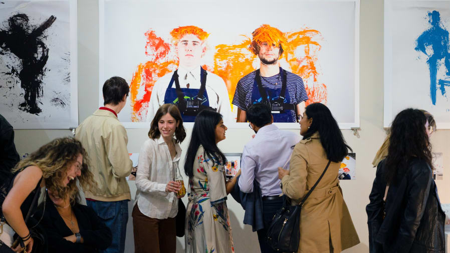 Group of people in the LCC gallery looking at work 