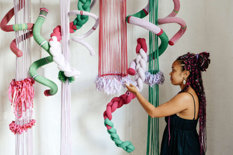 student admiring textile work