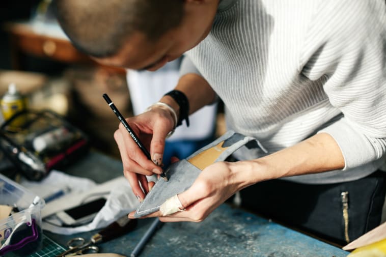 Boy working on a shoe 