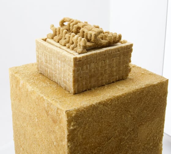 sand colour granules sculpture representing glyphs