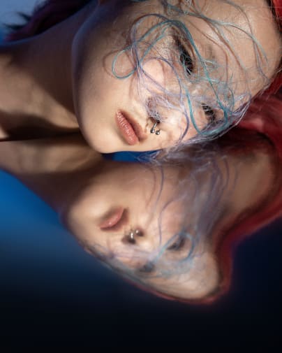 A female model wearing a face piece.