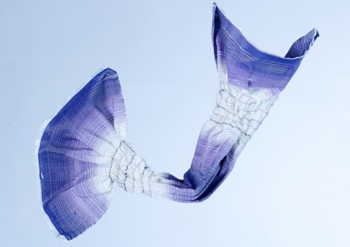 Picture of a violet and white fabric hanging in the air