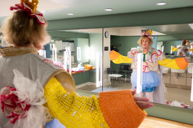 Grayson Perry trying on his 2022 robe in the mirror