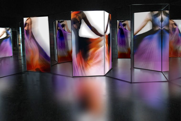 A dark room with lit up panels showing dresses, blurred to give the feeling of movement. MA Fashion Curation, Multimedia Installation by Daniel Caulfield-Sriklad