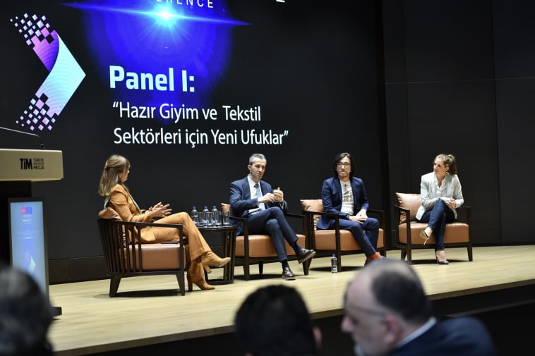 Four individuals take part in a panel discussion. 