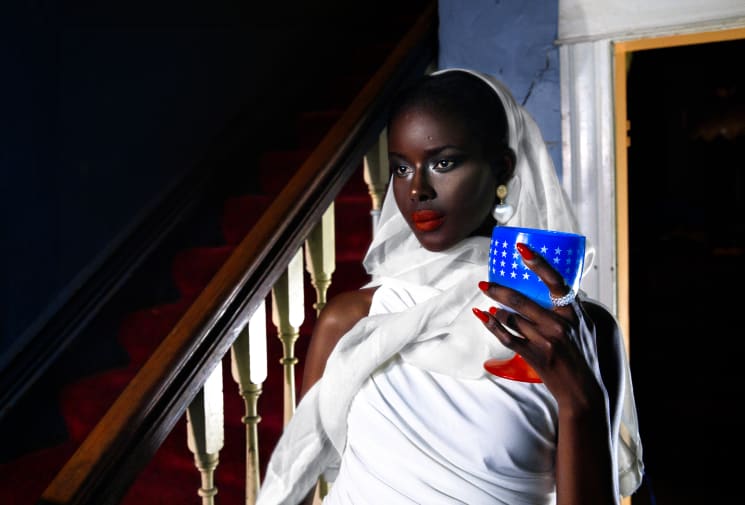 Female model in white scarf and strong red lipstick.