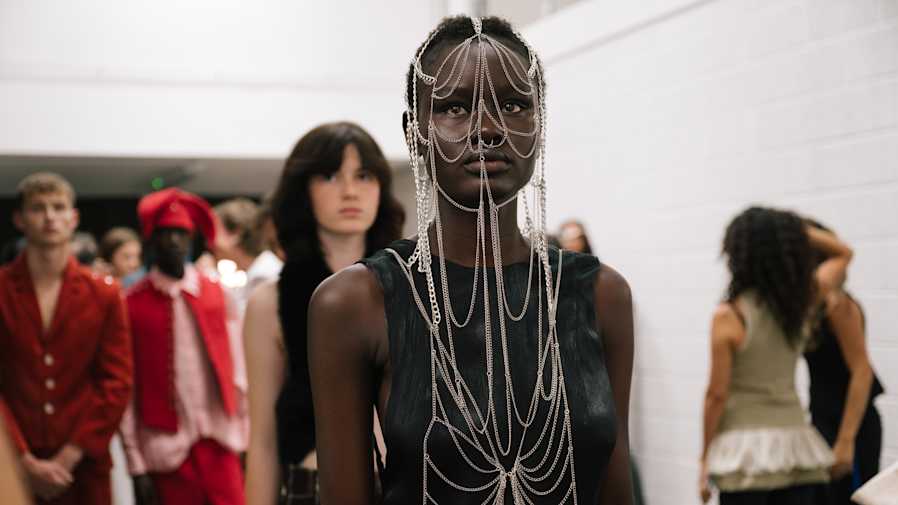 Photo of female and male models backstage at a fashion show