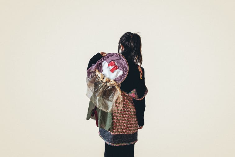 Female model carrying fabric.