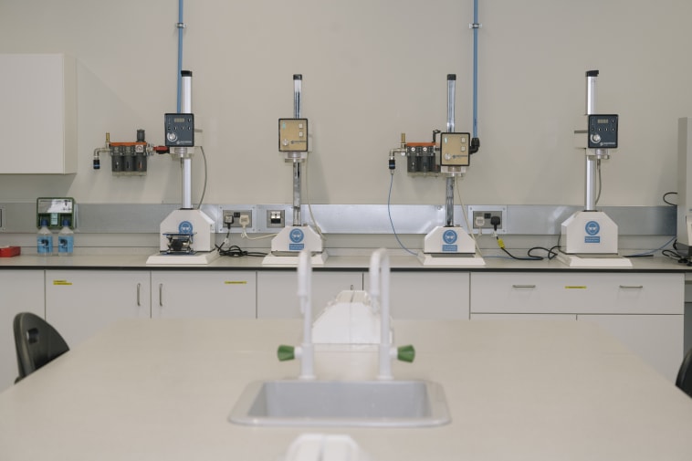 Laboratory with four machines on a table.