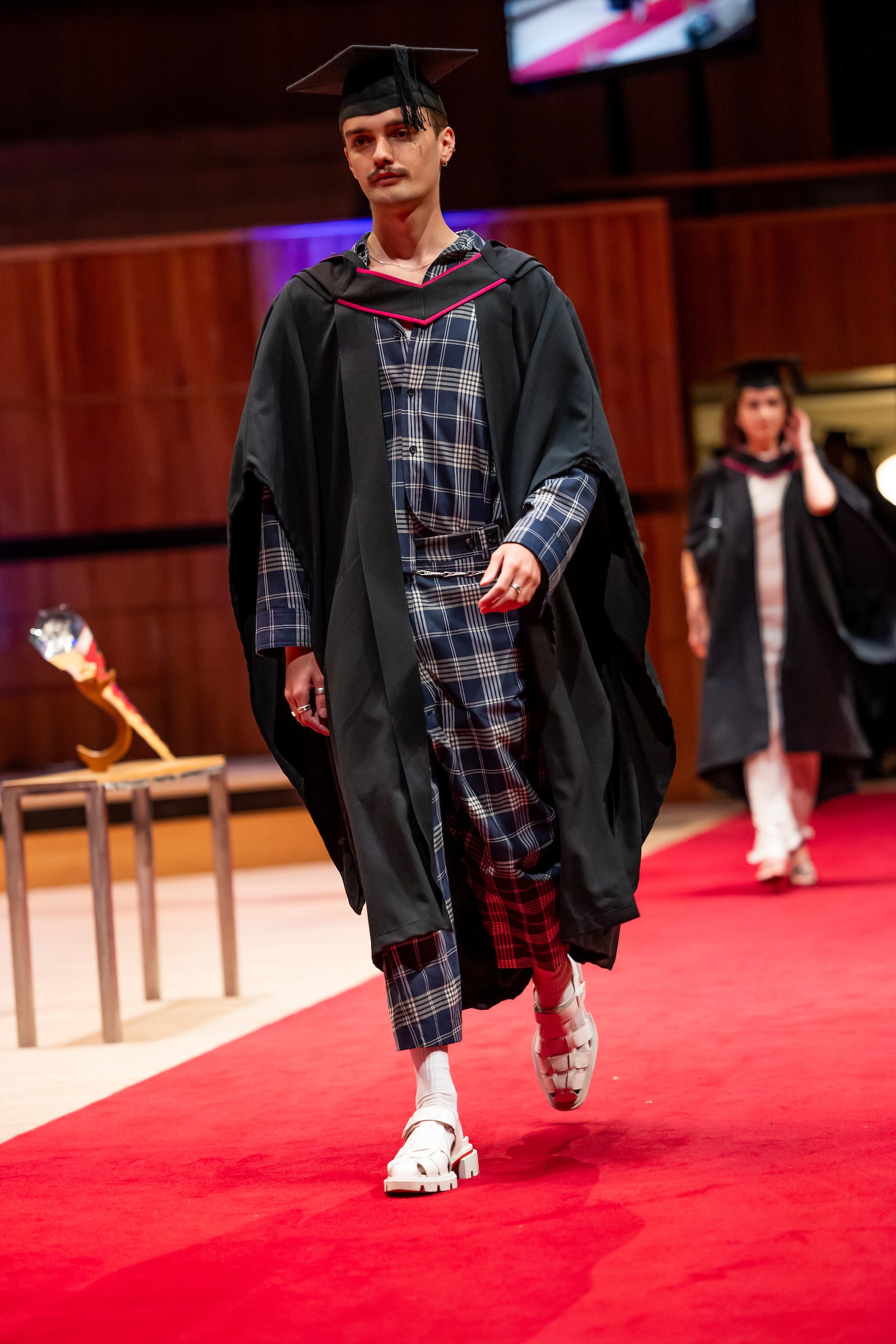 A graduate walking across the stage at graduation