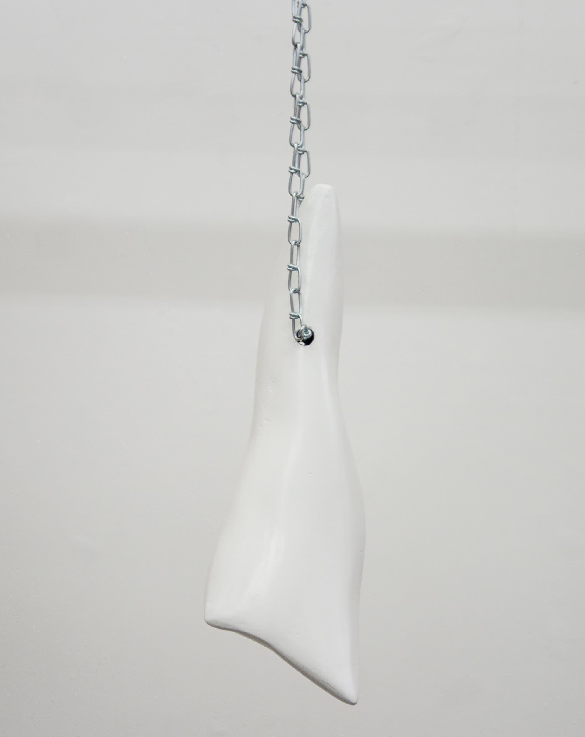 Images of cast teeth hanging by metal chain. 