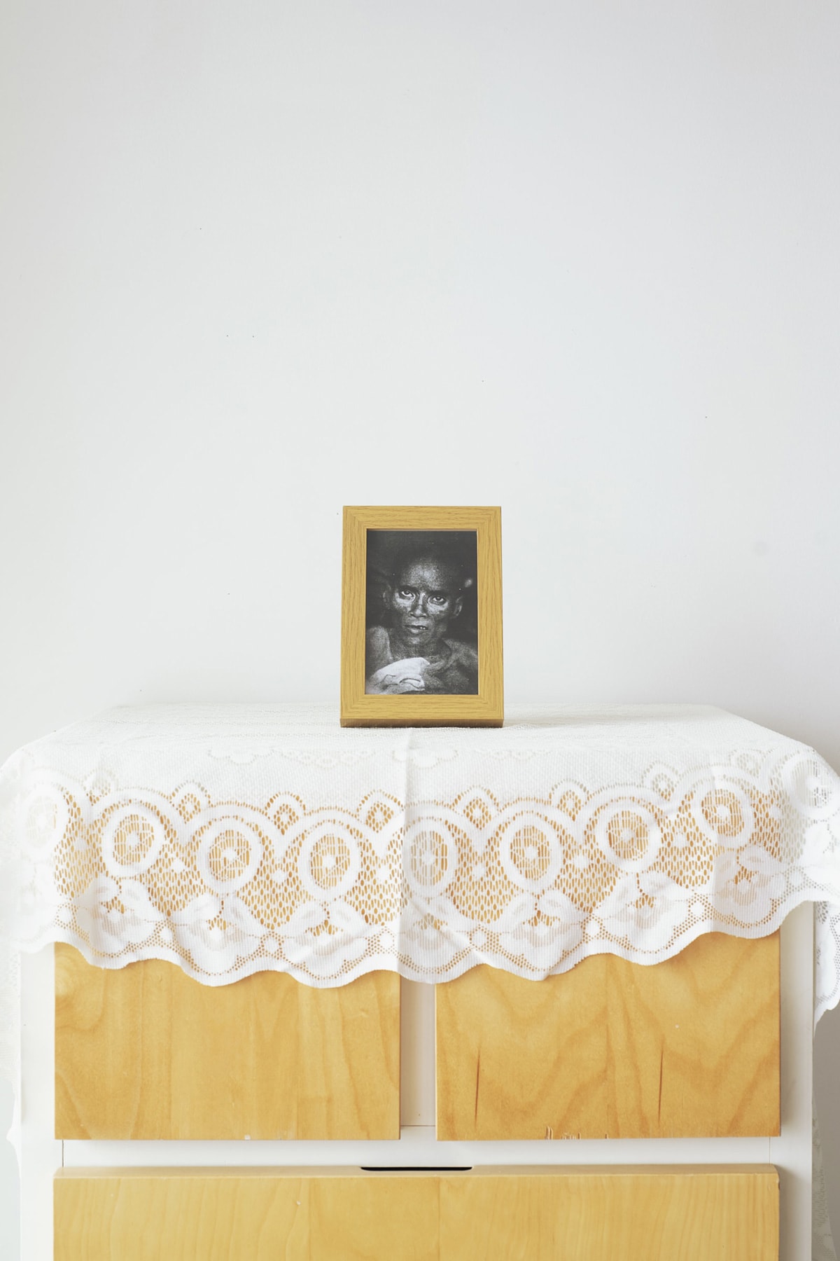 A photograph presented on a yellow-clothed table.