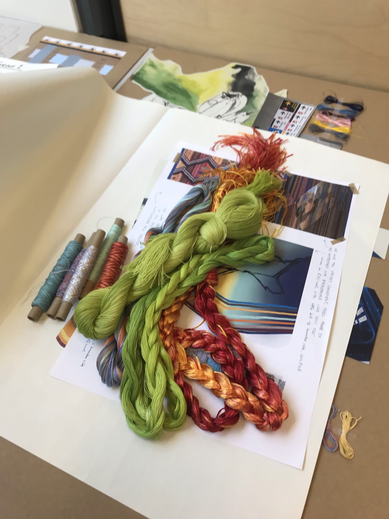 Fabric samples laid out on top of a page of design ideas