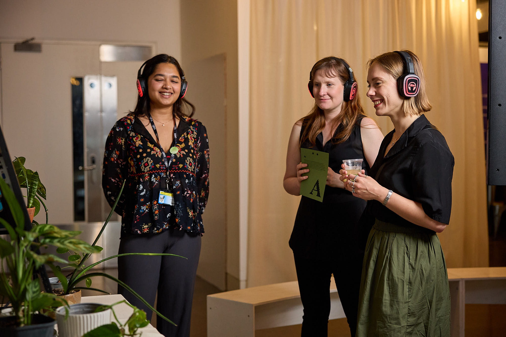 Three people wearing headphones 