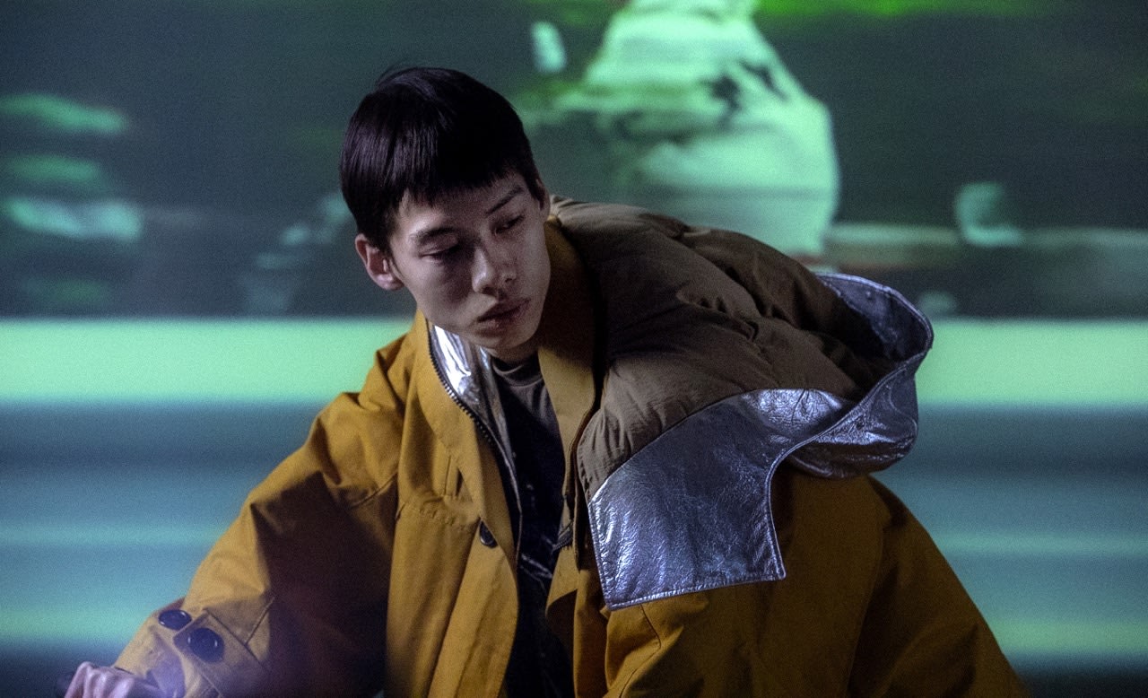 A person wearing a yellow quilted jacket