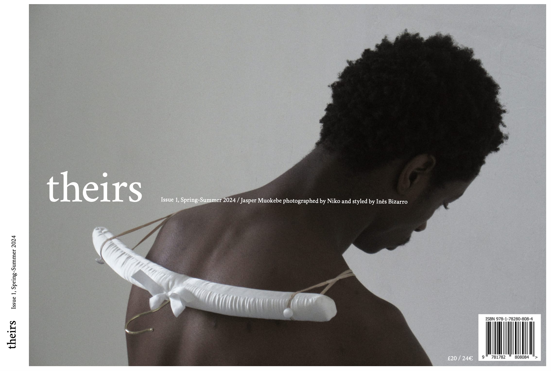 A person wearing a clothes hanger over their shoulders