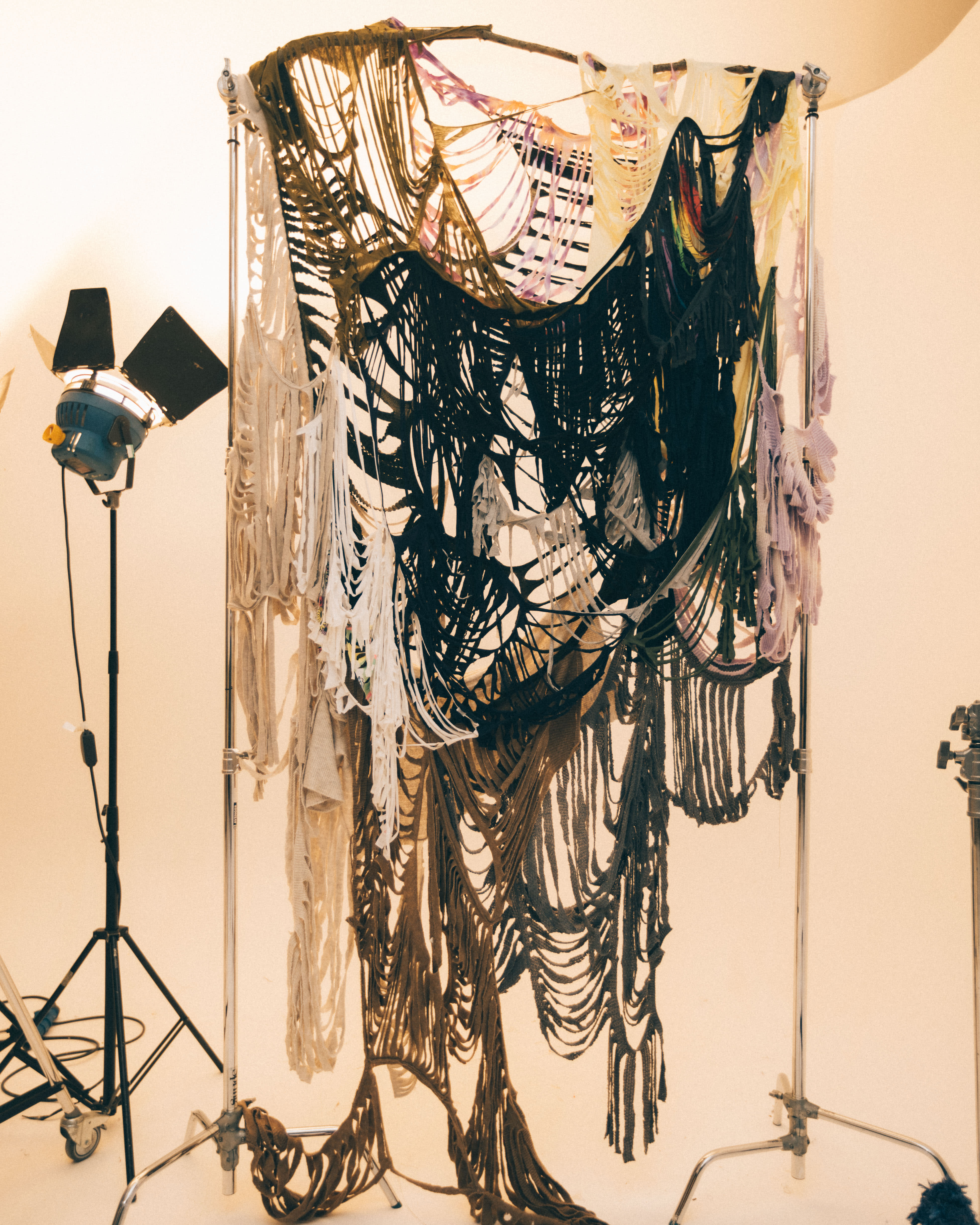 A woven piece of art hanging in a showroom