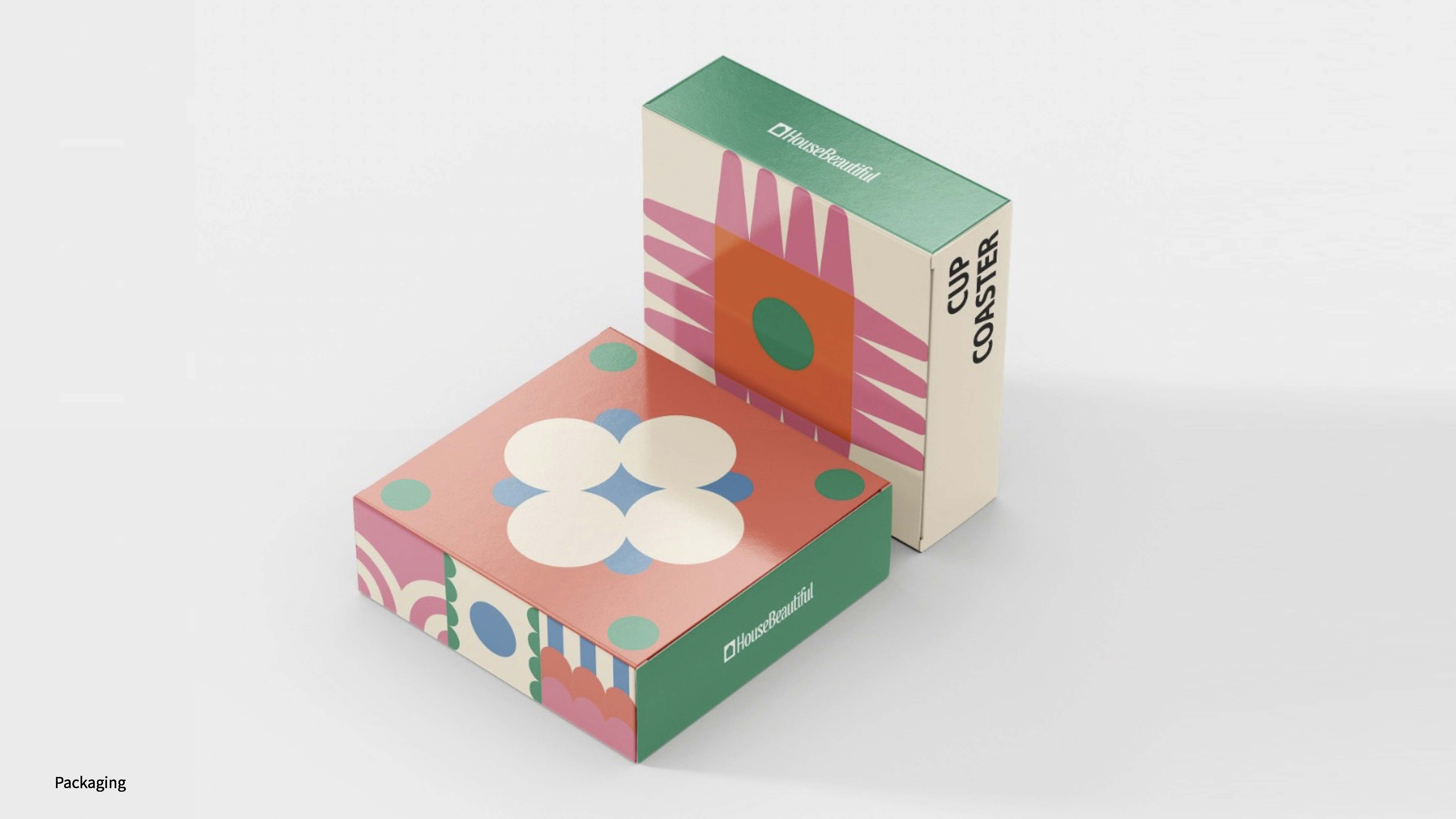 A mock-up of packaging for a House Beautiful coaster, featuring a bold colourful geometric pattern.
