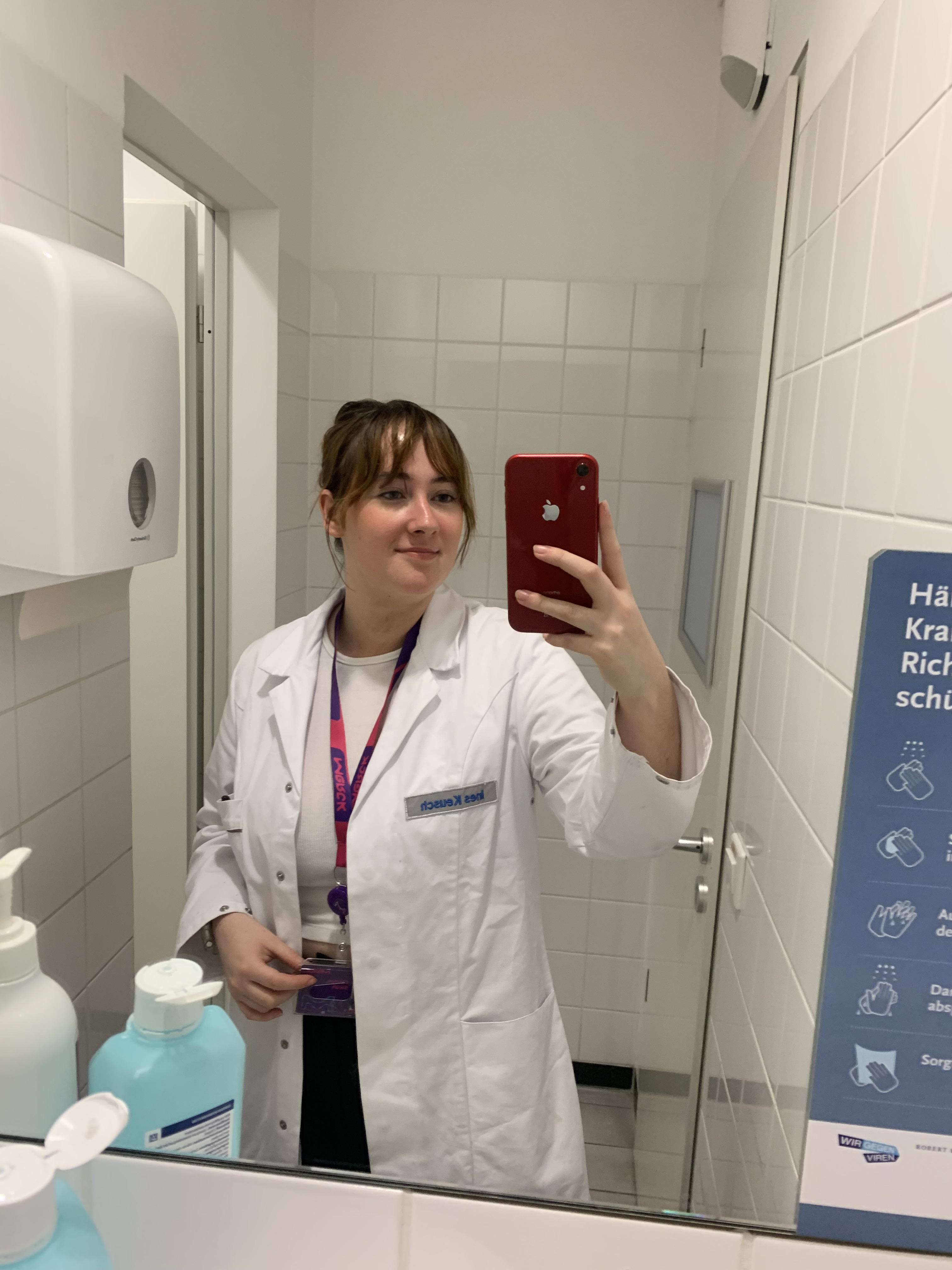 Sarah Clernon taking a selfie in the mirror at work on placement