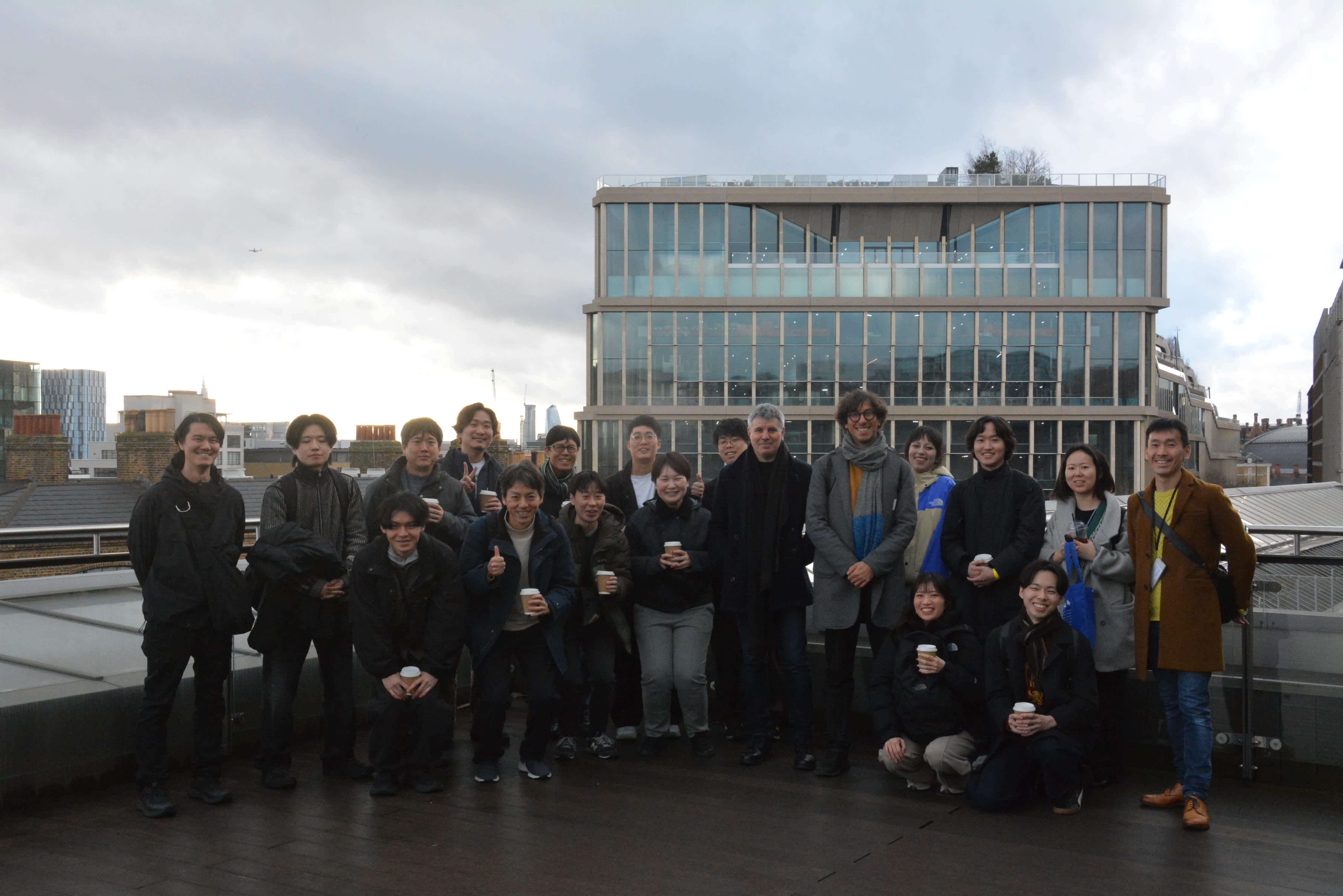 An image of a group of people on a rooftop posing for an image