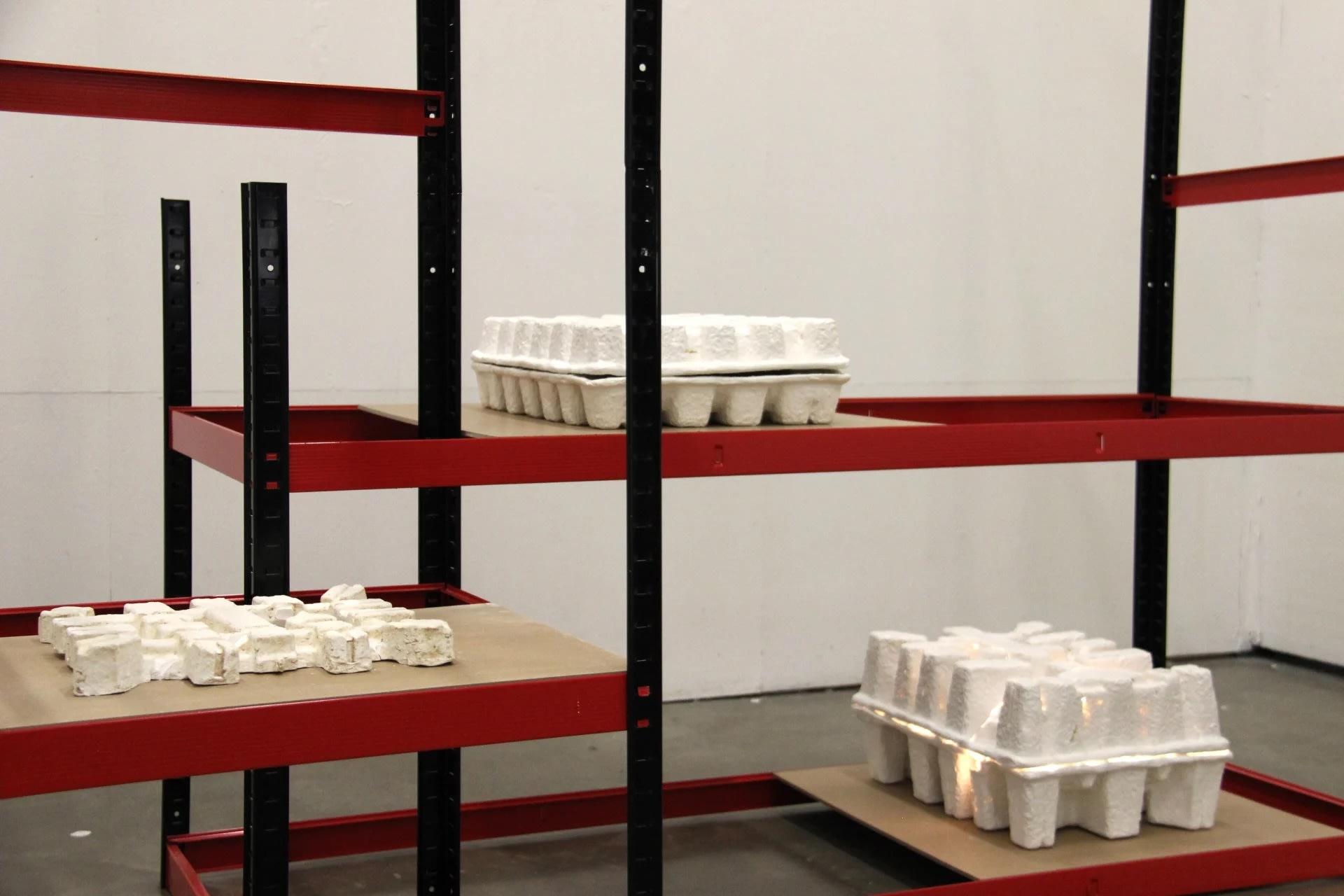 An image of an art installation of egg  cases on a wall