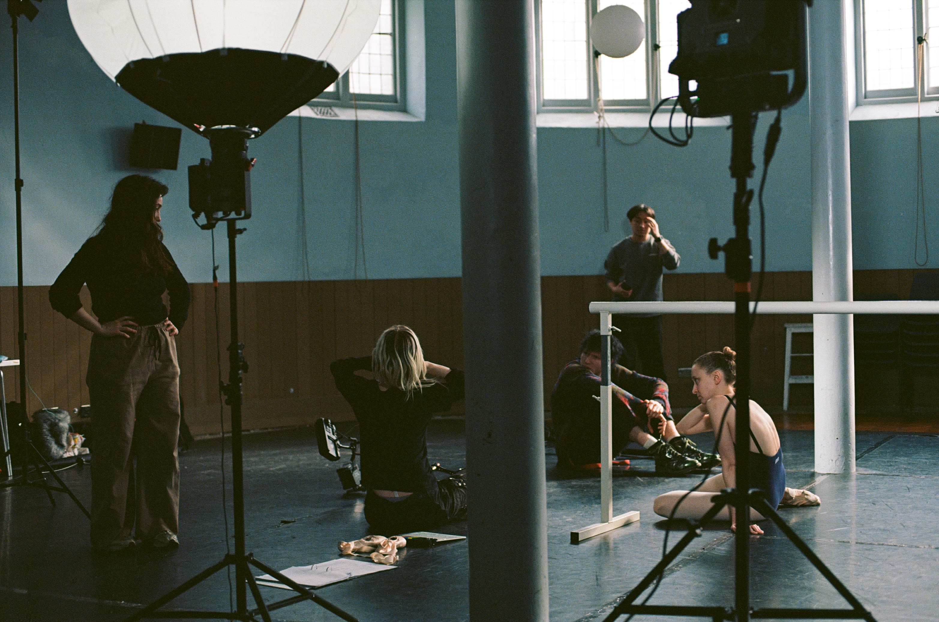 A film crew capturing a scene of a ballerina in a dance studio