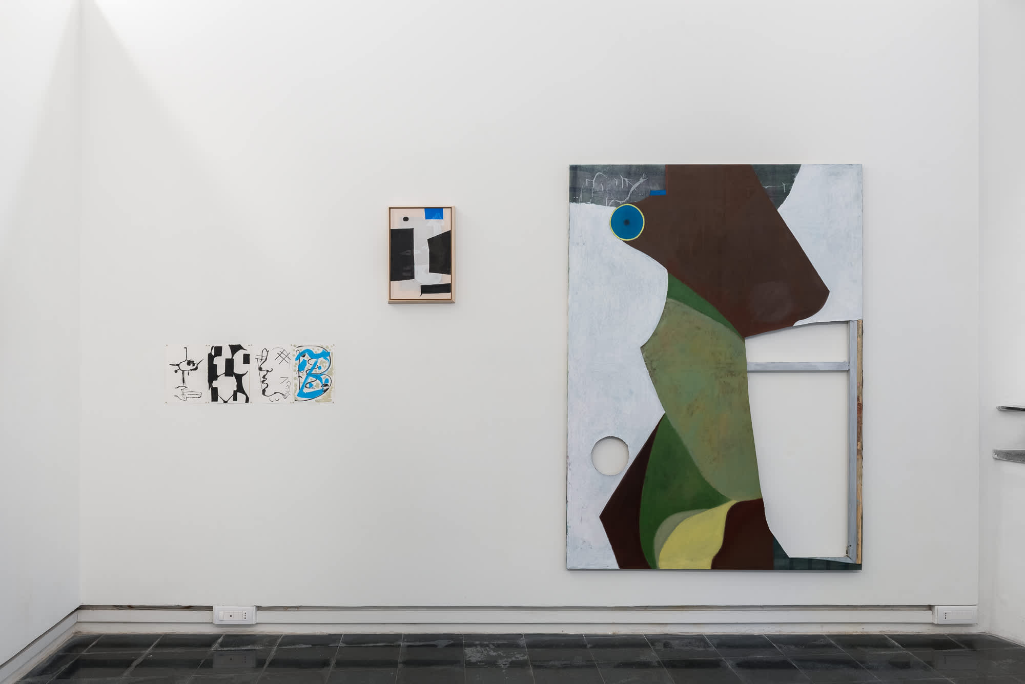 Installation view of a gallery space with a large abstract painting in green, brown and white tones displayed on a white wall alongside smaller framed and paper works.
