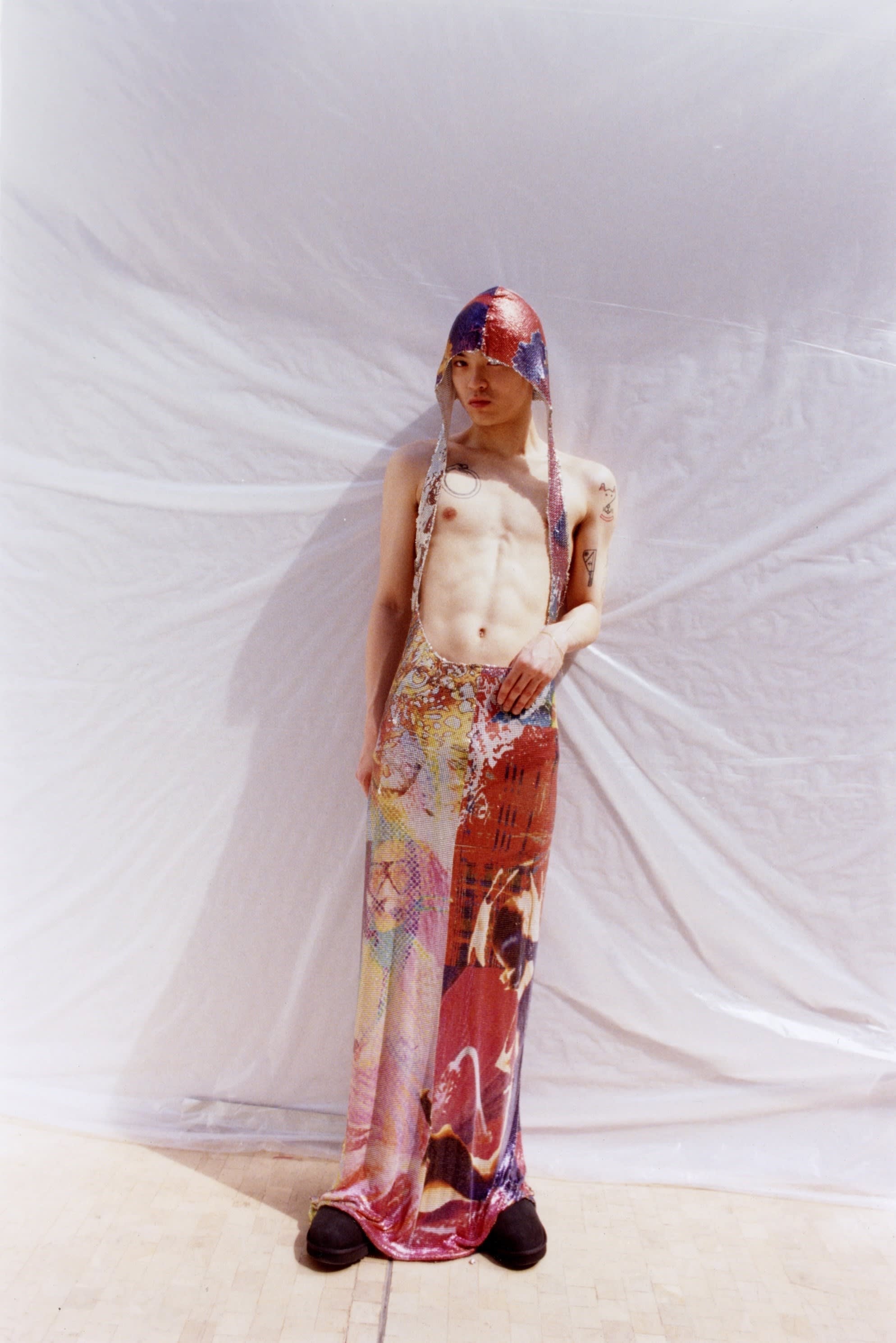 A person wearing a garment with a hood and a skirt and the middle part cut out