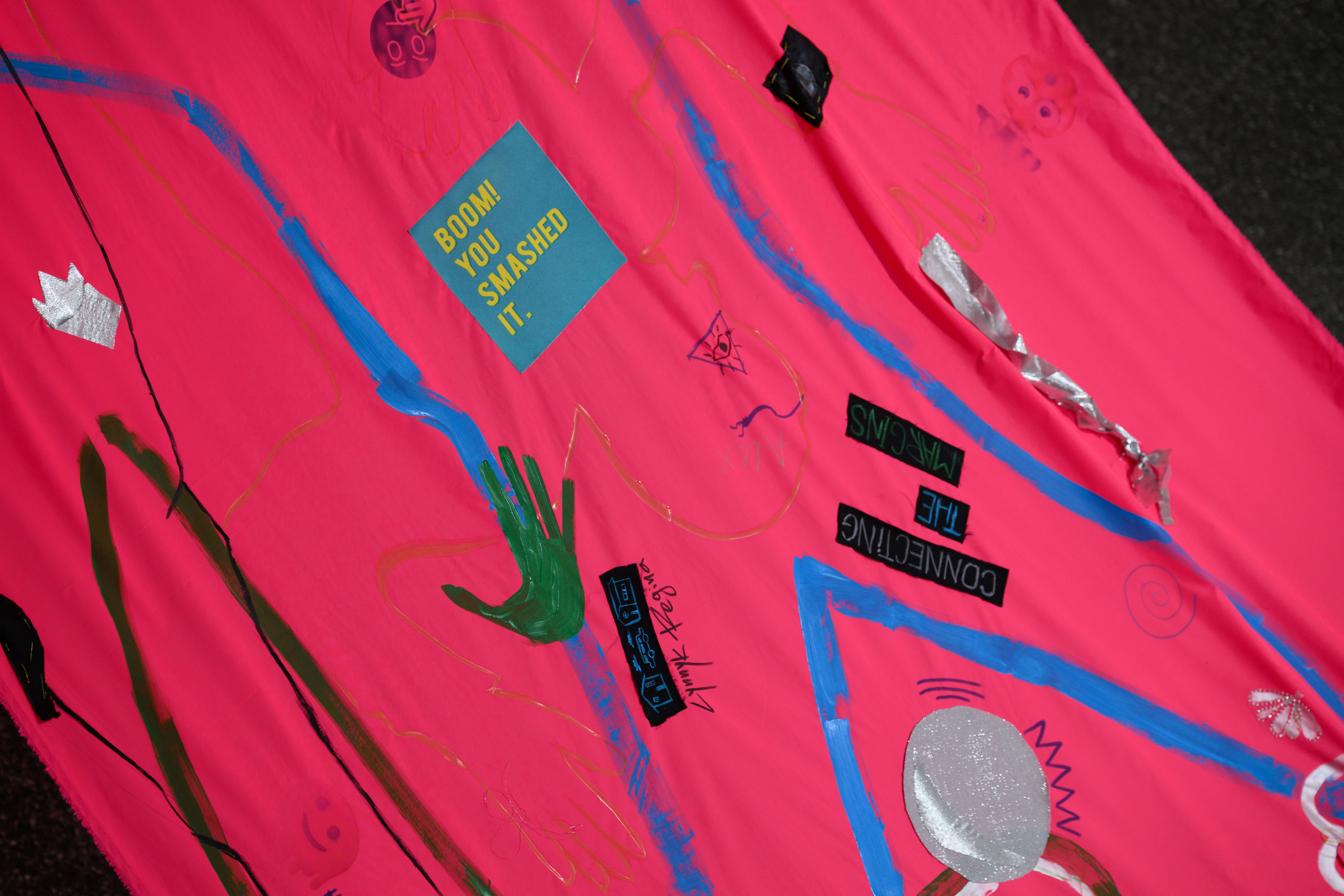 A close up shot of a large red background textile with individual motifs and designs 