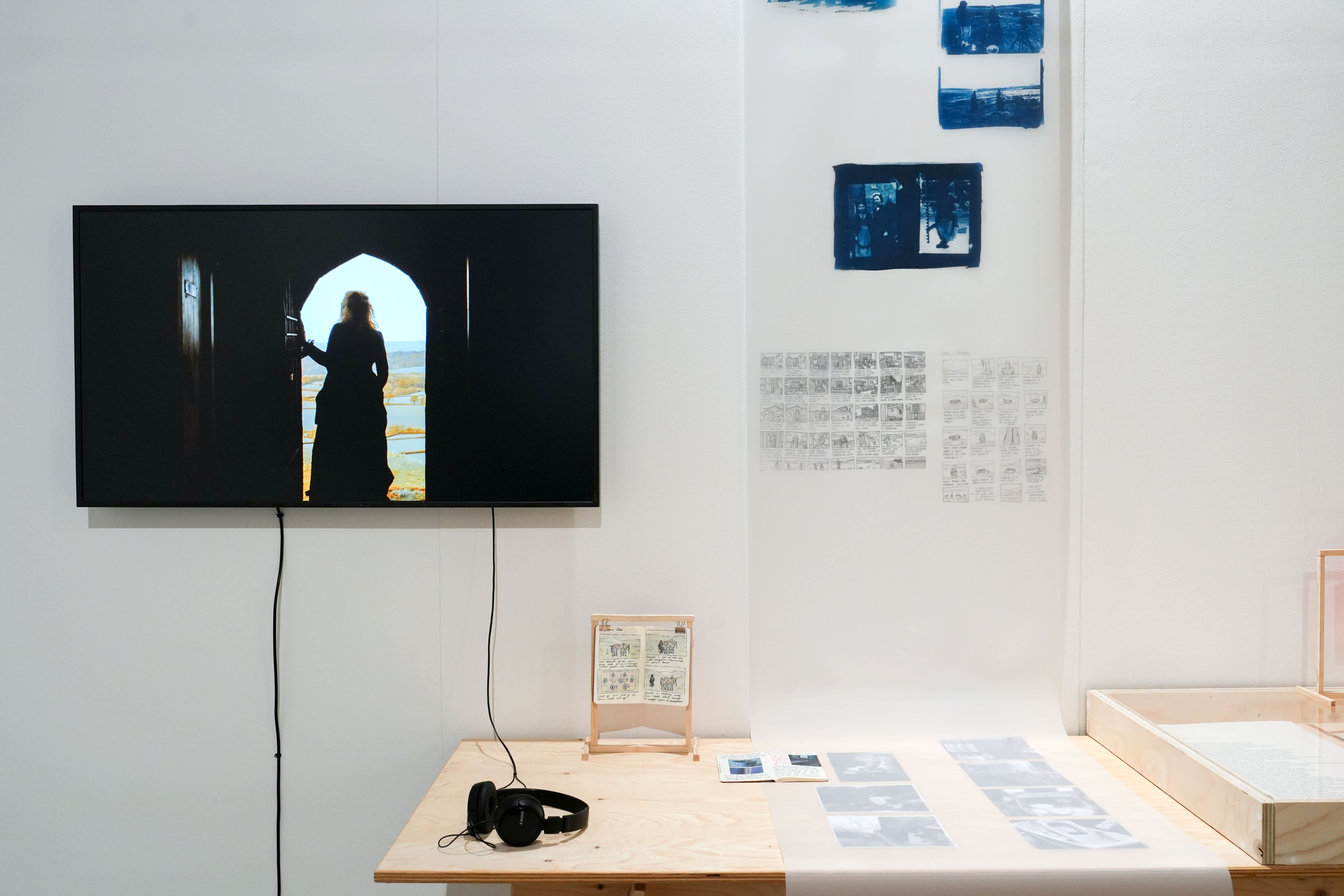 Installation view of the process exhibition with audiovisual and printed formats on display