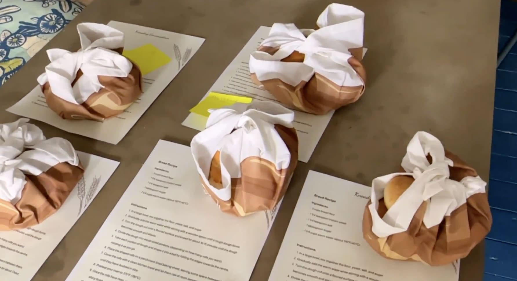 A colletion of wrapped objects on a table, as part of a student workshop.