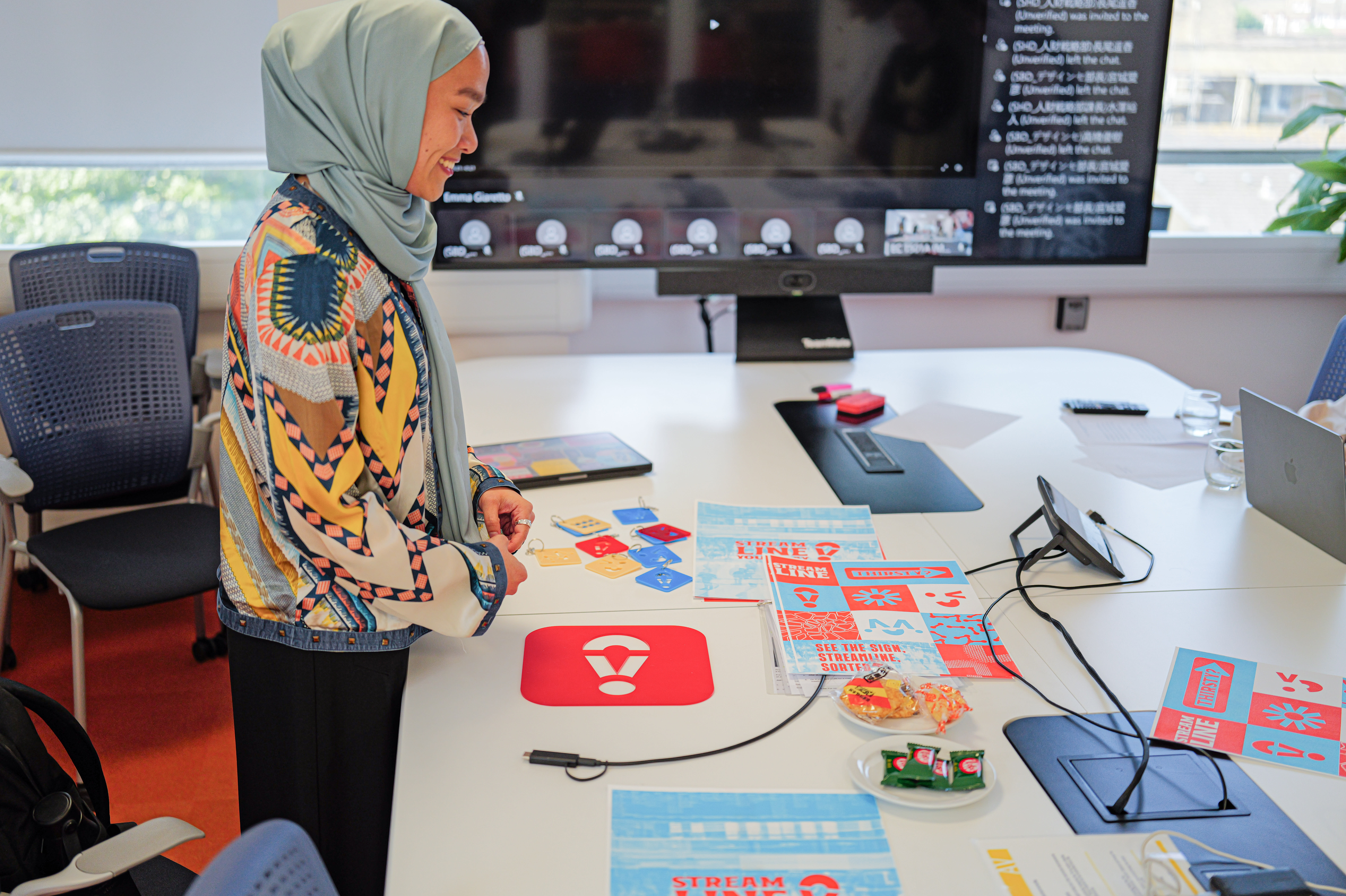 This a photo of a student presenting their concept to the Suntory Design team as part of this project.