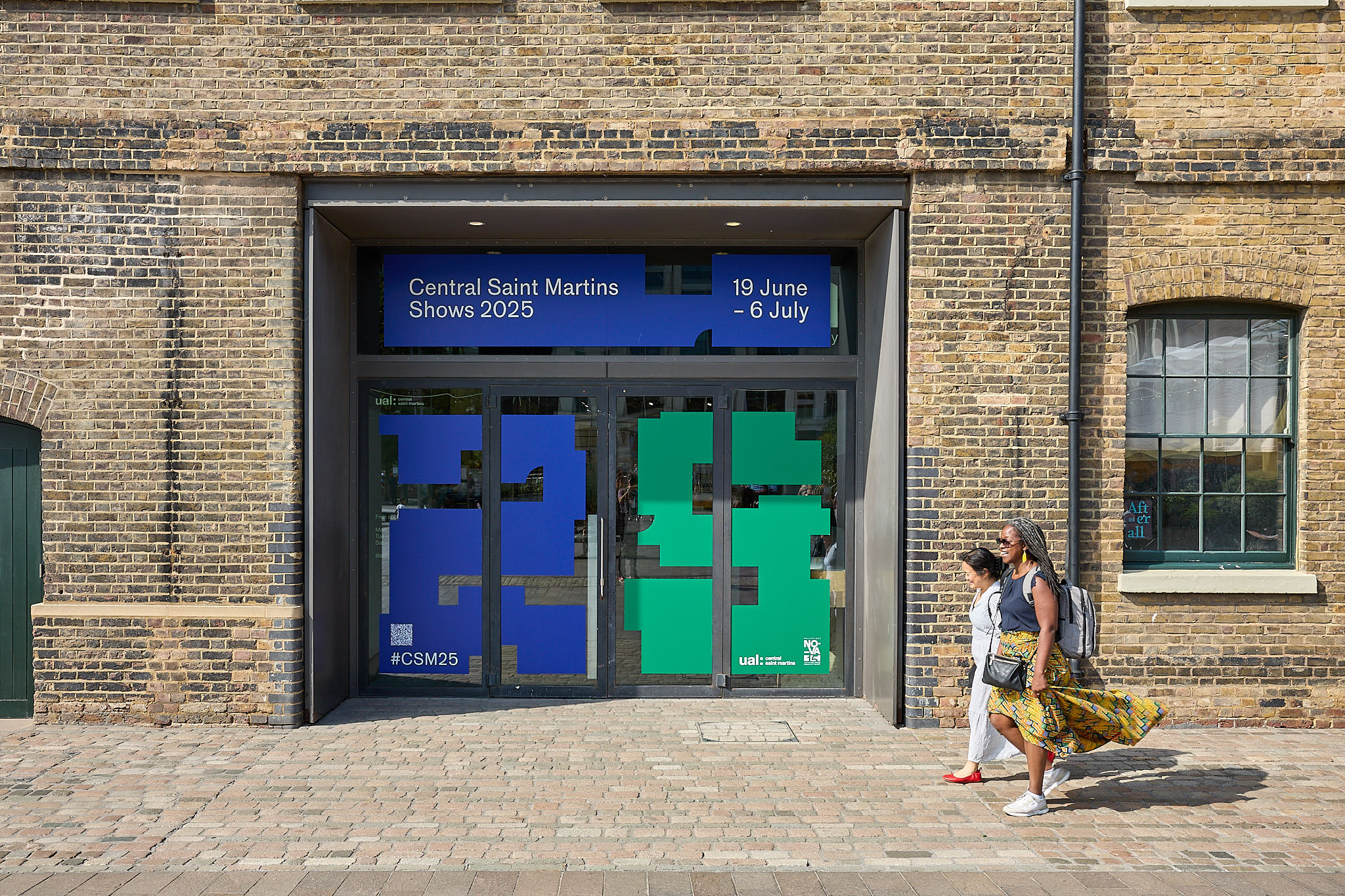 two women walk towards Granary Square