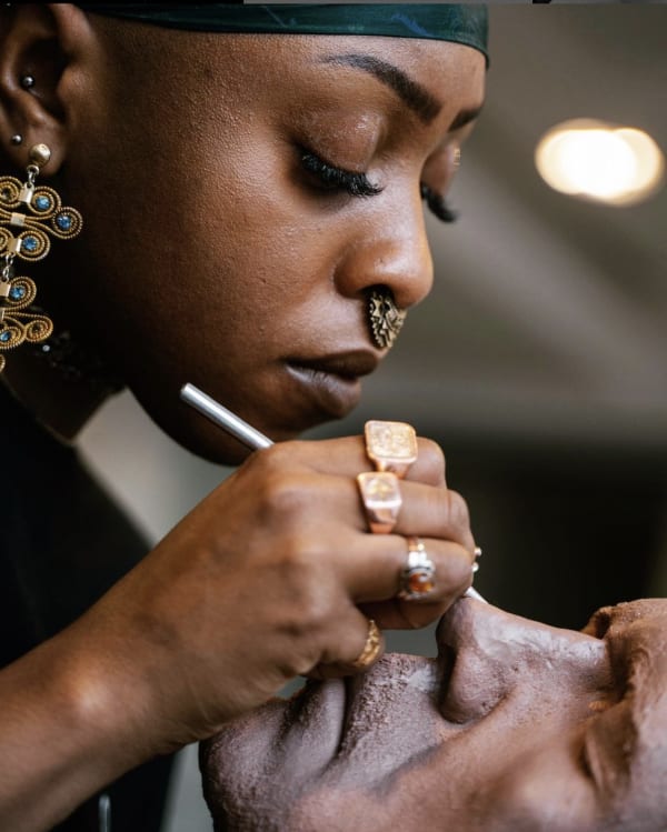 Image shows the digital sculptor Rayvenn Clarke at work on a model.