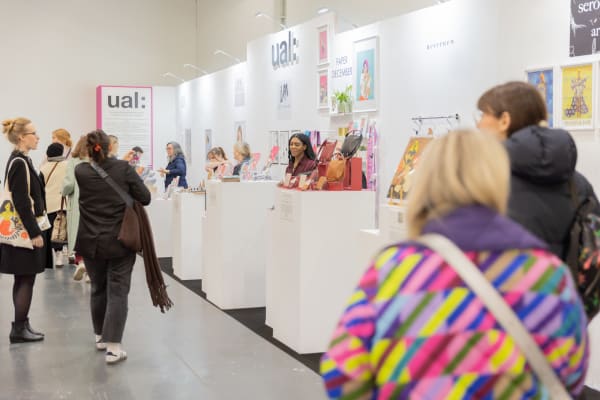 people viewing stalls at a trade show