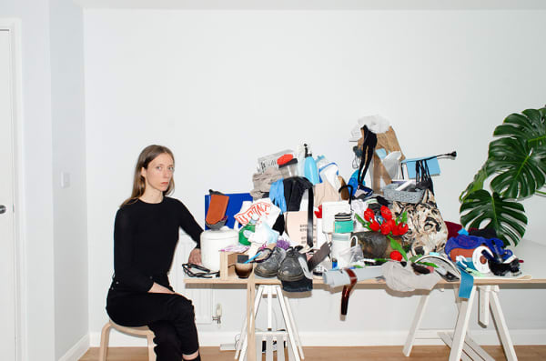 Figure sitting next to table covered with waste