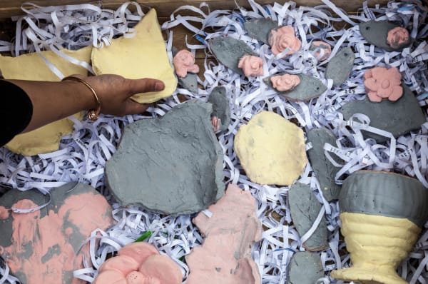 Hand reaching for clay objects
